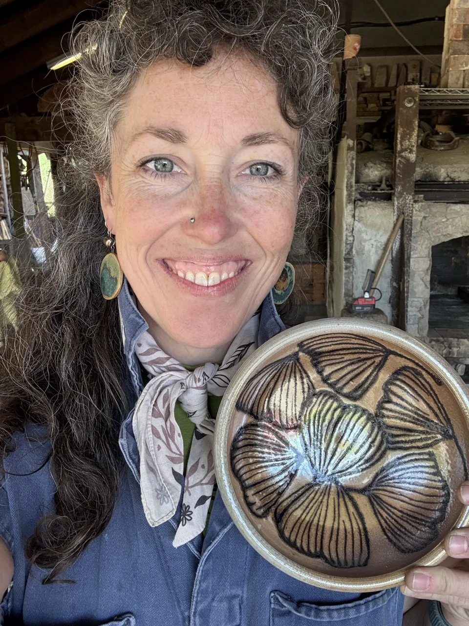 Erica holding a bowl with black gingko leaves