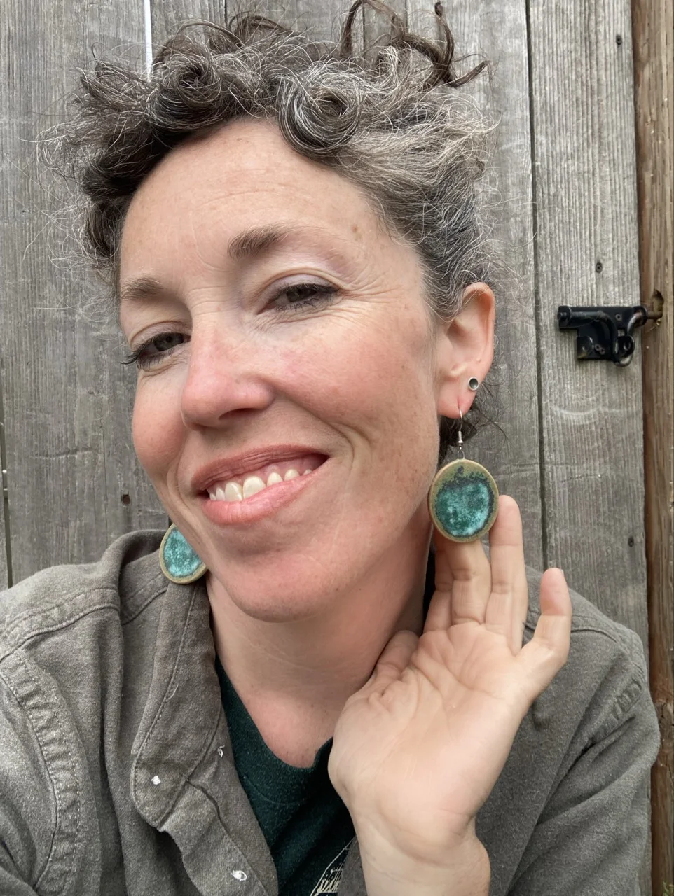 Erica modelling round green earings